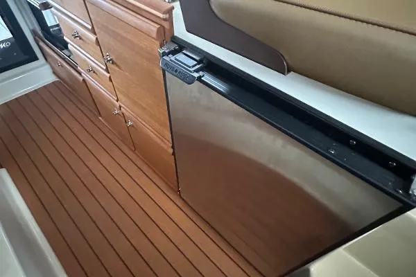  Yacht Photos Pics Interior of 2021 Ranger Tugs R-27 with wood cabinetry and stainless steel appliances.
