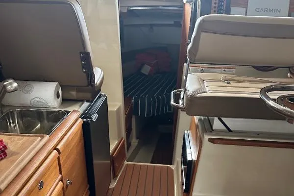  Yacht Photos Pics 2021 Ranger Tugs R-27 interior with kitchenette, seating, and cabin view.