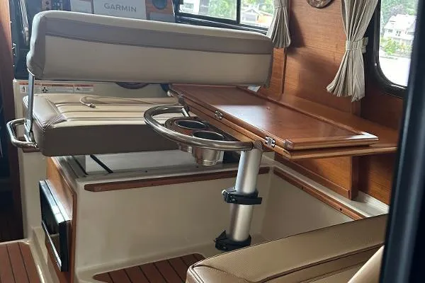  Yacht Photos Pics Interior of 2021 Ranger Tugs R-27 boat with seating and wooden table.