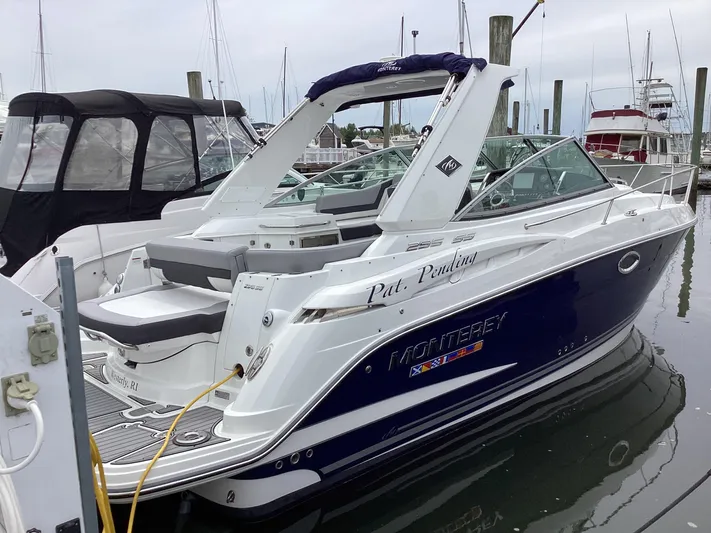 Pat.pending Yacht Photos Pics 2022 Monterey 295 Sport Yacht docked at marina, featuring sleek design and modern amenities.