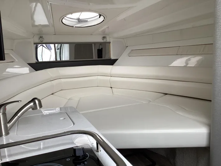 Pat.pending Yacht Photos Pics Interior of 2022 Monterey 295 Sport Yacht with sleek white seating and modern fixtures.