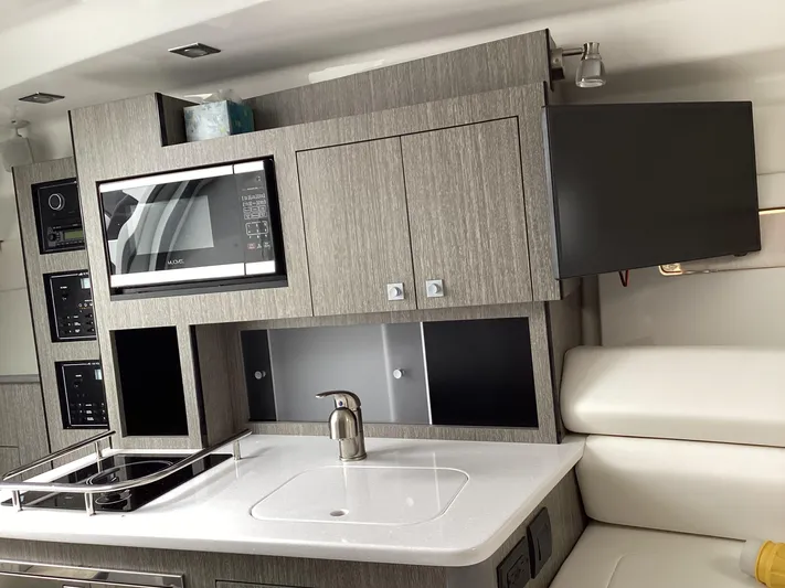 Pat.pending Yacht Photos Pics Modern kitchen interior of 2022 Monterey 295 Sport Yacht with microwave and sink.