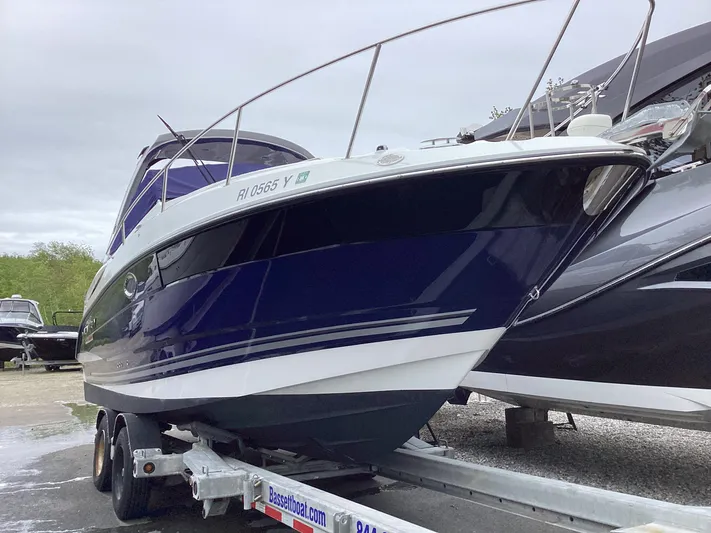 Pat.pending Yacht Photos Pics 2022 Monterey 295 Sport Yacht on trailer, sleek design, blue and white hull.