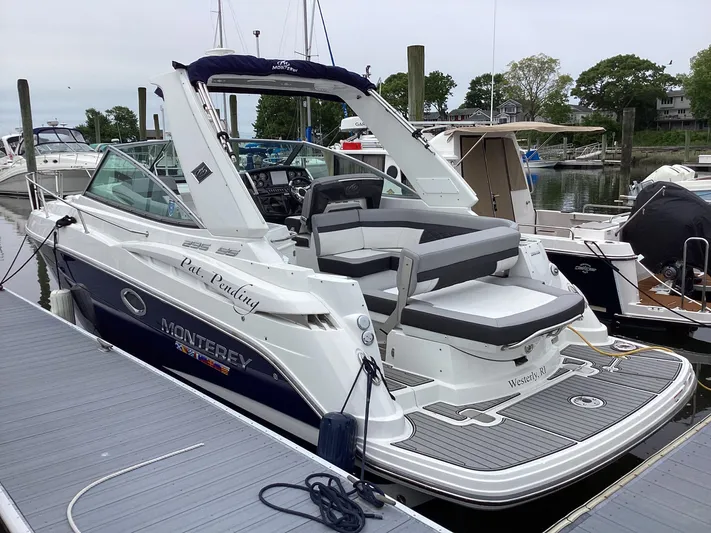 Pat.pending Yacht Photos Pics 2022 Monterey 295 Sport Yacht docked, featuring sleek design and spacious seating.