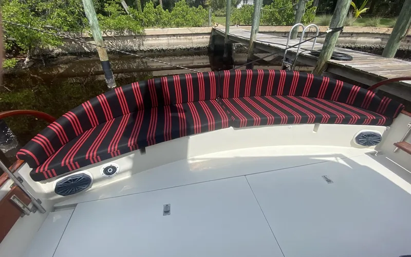 Sirena Yacht Photos Pics Red and black striped seating on 1986 Midnight Lace 52 Flybridge boat deck.