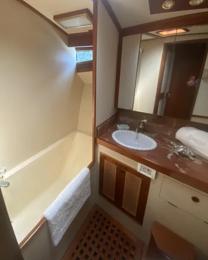 Sirena Yacht Photos Pics Bathroom interior of 1986 Midnight Lace 52 Flybridge yacht, featuring sink and shower.