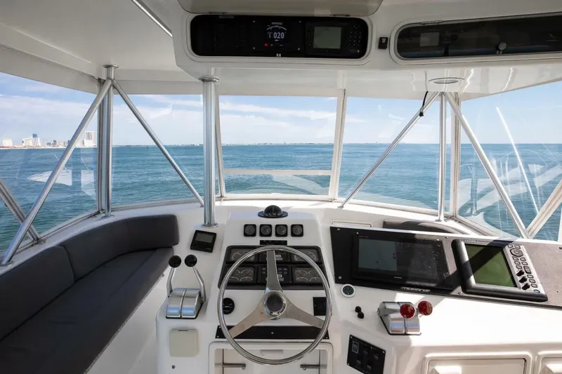  Yacht Photos Pics 1999 Ocean Yachts 48 Super Sport helm with ocean view, featuring navigation equipment and steering wheel.