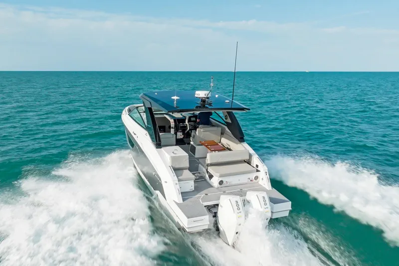  Yacht Photos Pics 2026 Cruisers Yachts 34 GLS OB cruising on open sea, rear view.