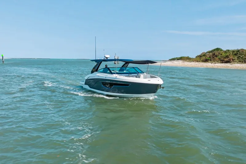  Yacht Photos Pics 2026 Cruisers Yachts 34 GLS OB navigating coastal waters under clear skies.