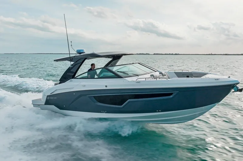  Yacht Photos Pics 2026 Cruisers Yachts 34 GLS OB speeding on open water, showcasing sleek design and performance.