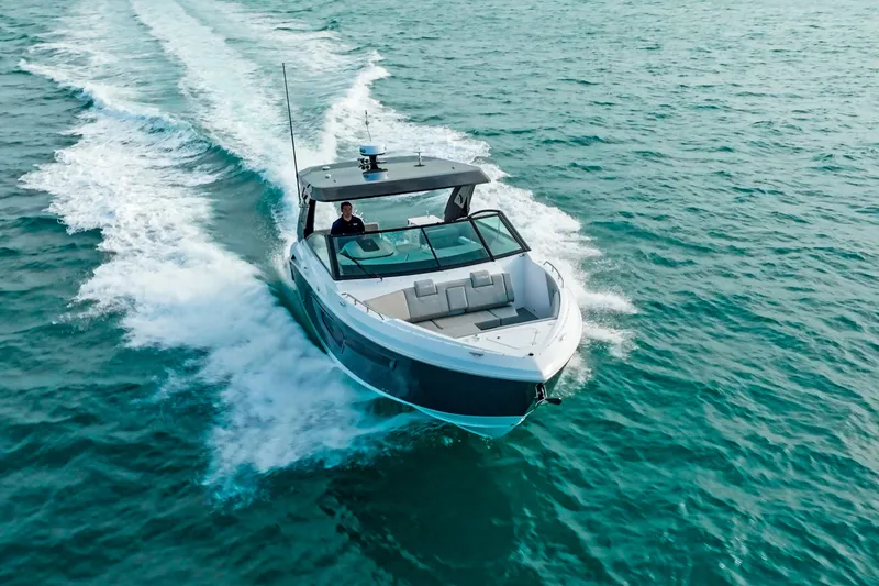  Yacht Photos Pics 2026 Cruisers Yachts 34 GLS OB cruising on open water, showcasing sleek design and performance.