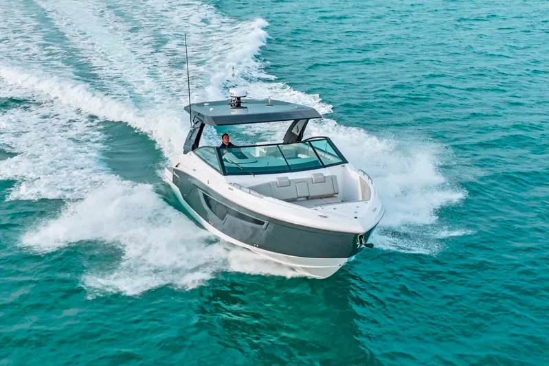  Yacht Photos Pics 2026 Cruisers Yachts 34 GLS OB cruising on clear blue water.