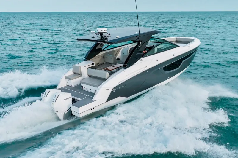  Yacht Photos Pics 2026 Cruisers Yachts 34 GLS OB cruising on open water, showcasing sleek design and powerful engines.