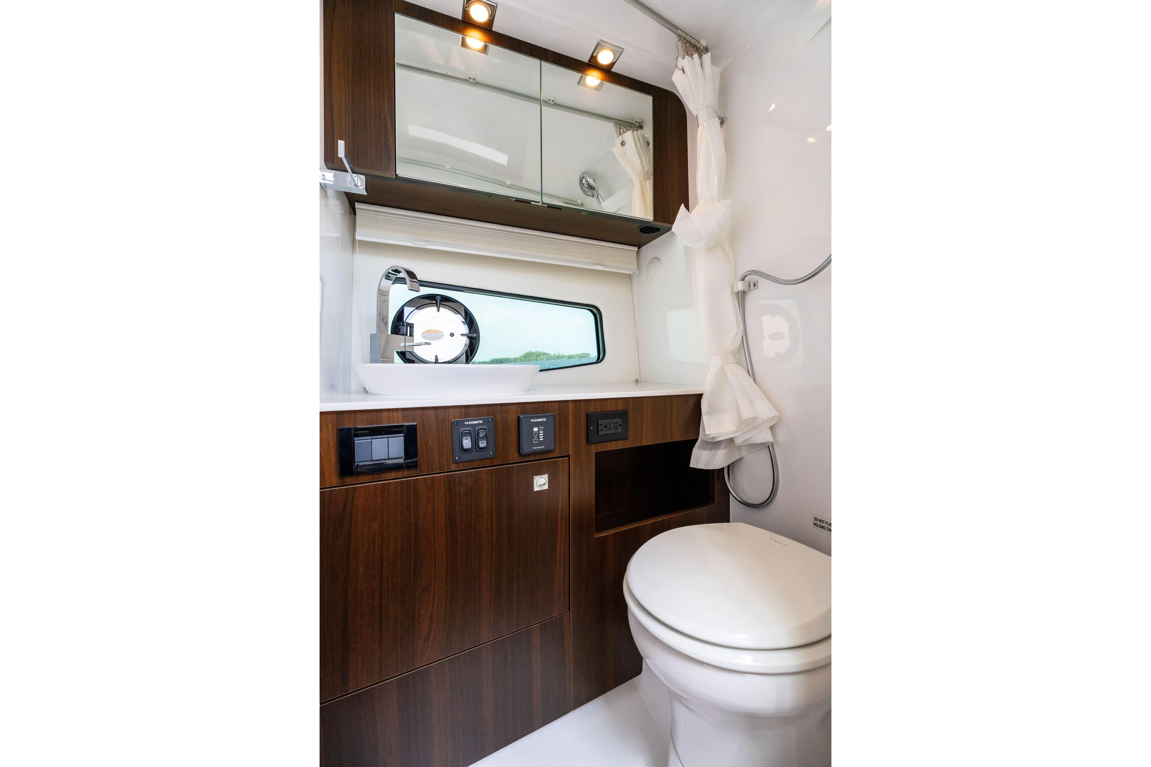  Yacht Photos Pics Luxurious bathroom in 2026 Cruisers Yachts 34 GLS OB, featuring modern fixtures and wood accents.