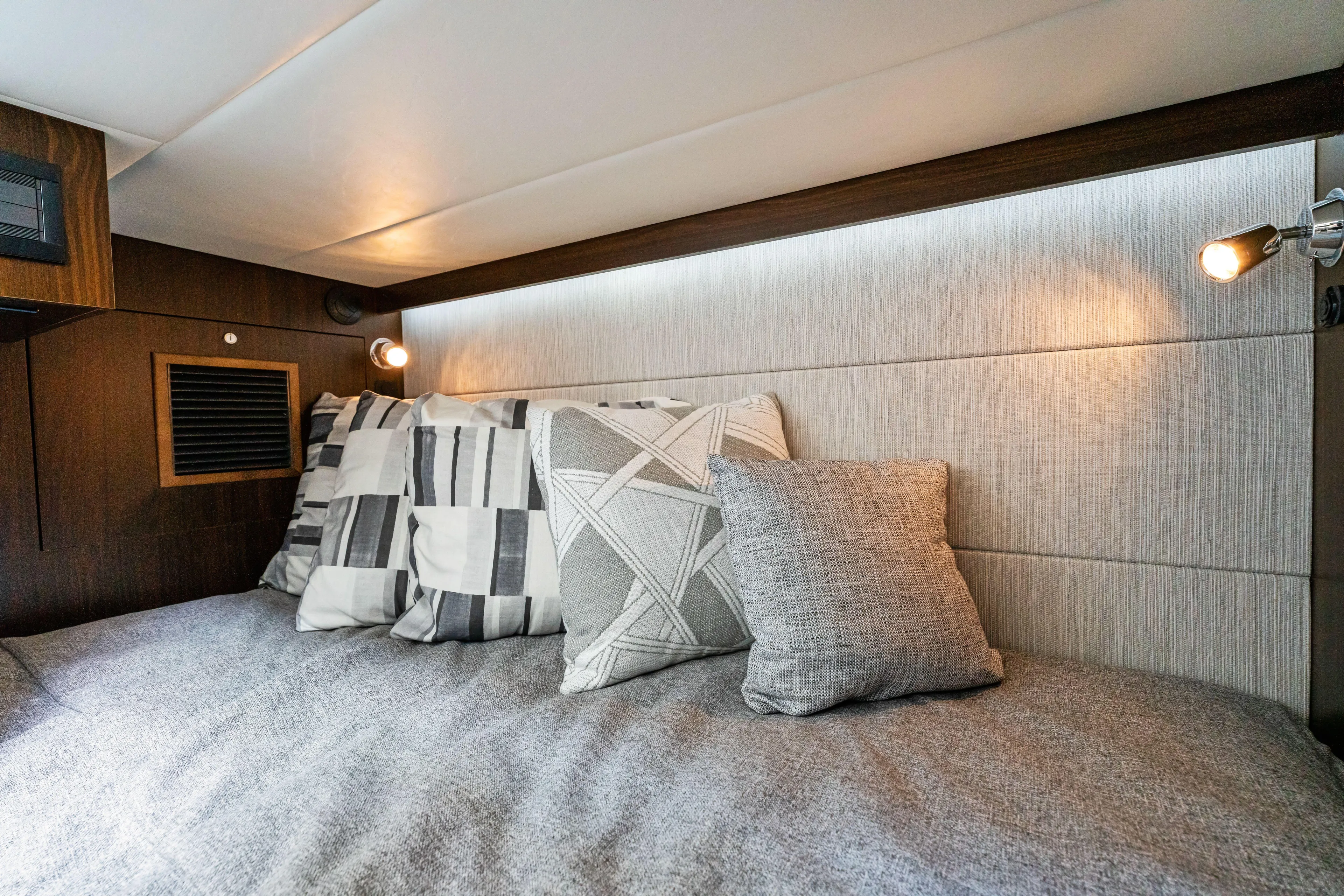  Yacht Photos Pics Luxurious cabin interior of 2026 Cruisers Yachts 34 GLS OB with stylish pillows and lighting.