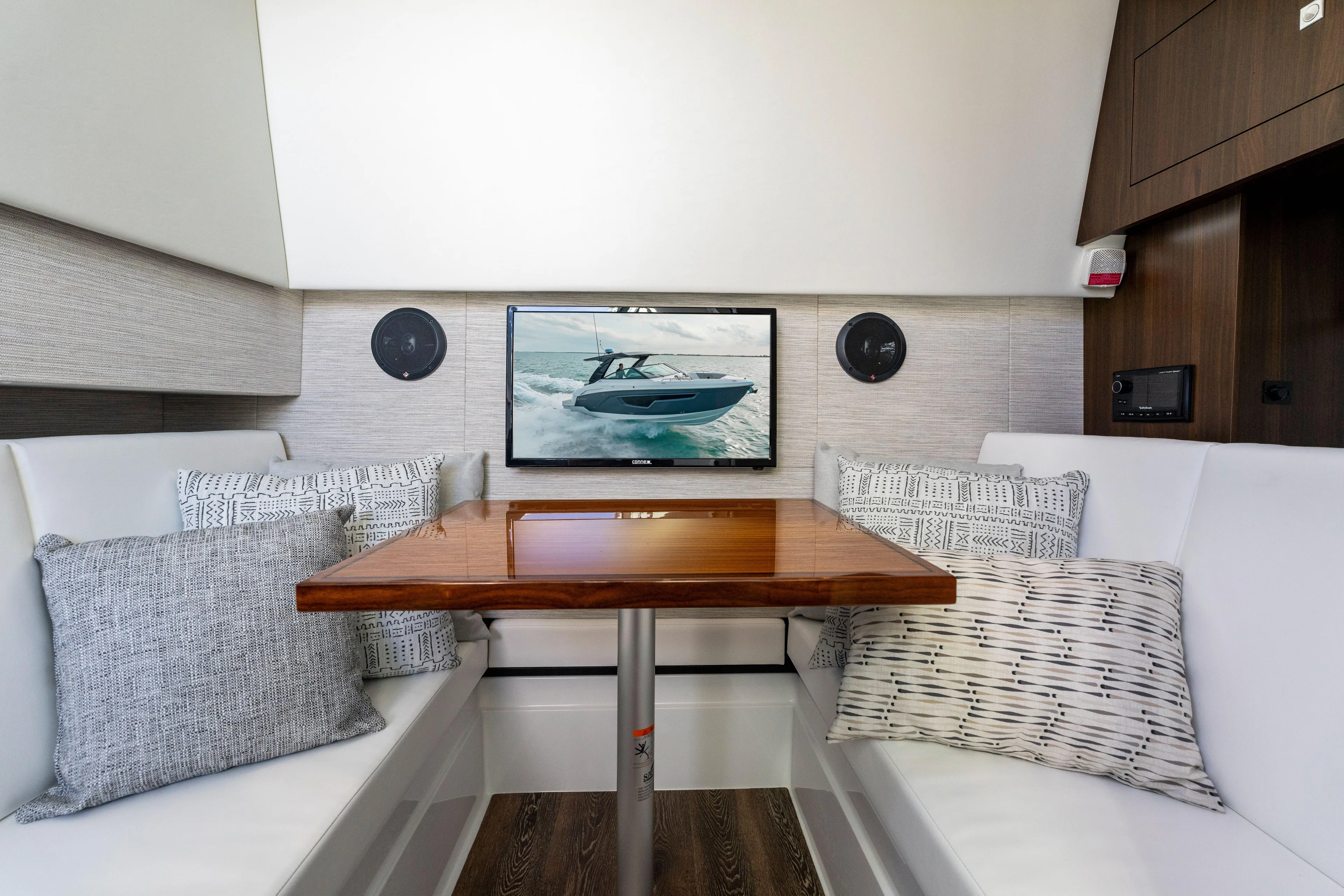 Yacht Photos Pics Interior of 2026 Cruisers Yachts 34 GLS OB with cozy seating and TV display.