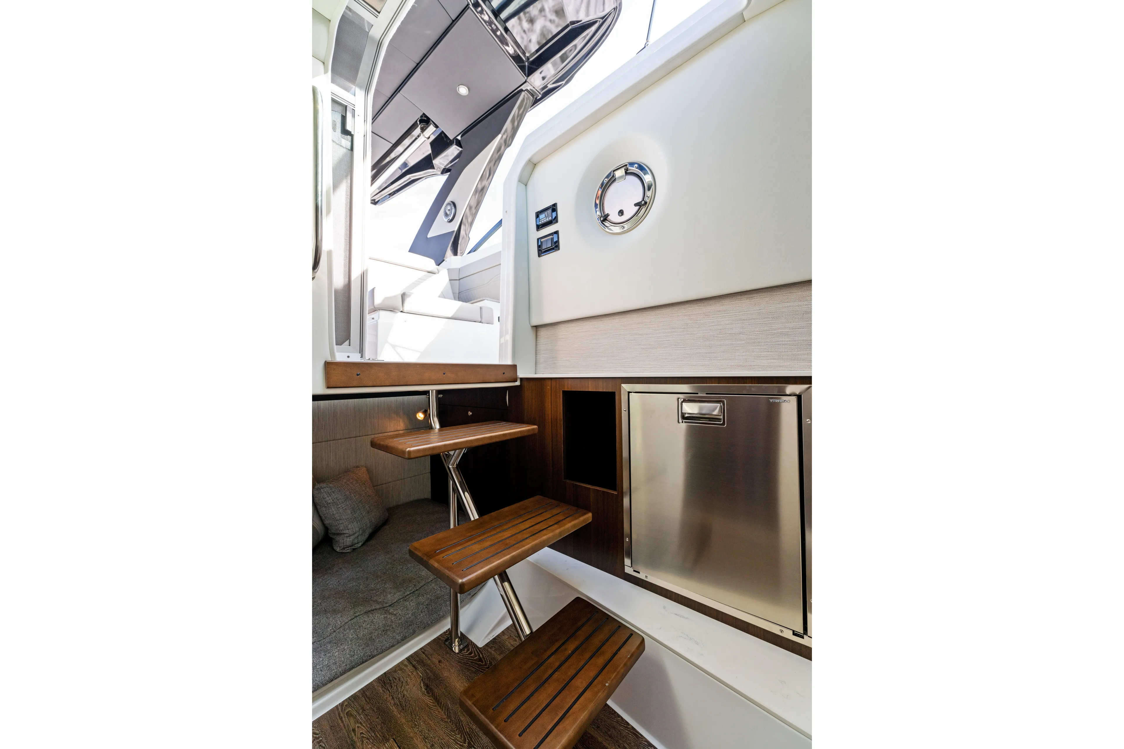  Yacht Photos Pics Interior of 2026 Cruisers Yachts 34 GLS OB, featuring wooden steps and stainless steel accents.