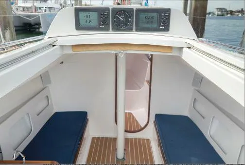 J/111 Yacht Photos Pics 2013 J Boats J/111 interior with blue cushions and navigation instruments.