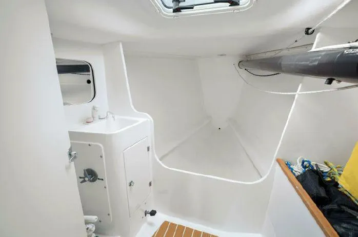 J/111 Yacht Photos Pics 2013 J Boats J/111 interior cabin with sleek white design and compact amenities.