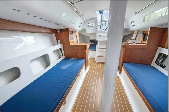 J/111 Yacht Photos Pics Interior of 2013 J Boats J/111 sailboat with blue cushions and wood accents.