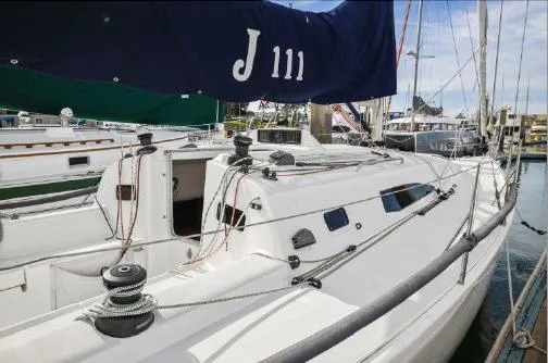 J/111 Yacht Photos Pics 2013 J Boats J/111 sailboat docked at marina, featuring sleek white design.