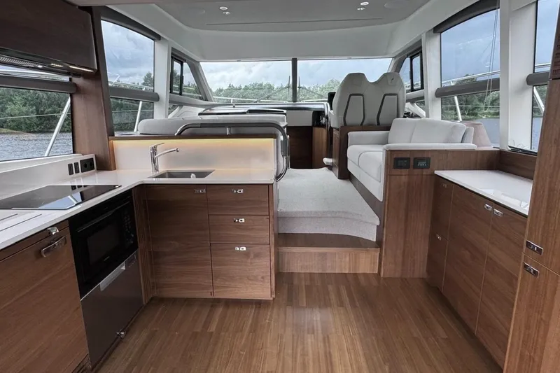 Yacht Photos Pics Luxurious interior of 2022 Princess F50 yacht with modern kitchen and seating area.