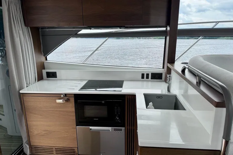  Yacht Photos Pics Modern kitchen area on 2022 Princess F50 yacht with sleek design and appliances.