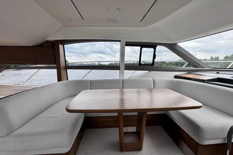  Yacht Photos Pics Luxurious interior of 2022 Princess F50 yacht with elegant seating and wooden table.