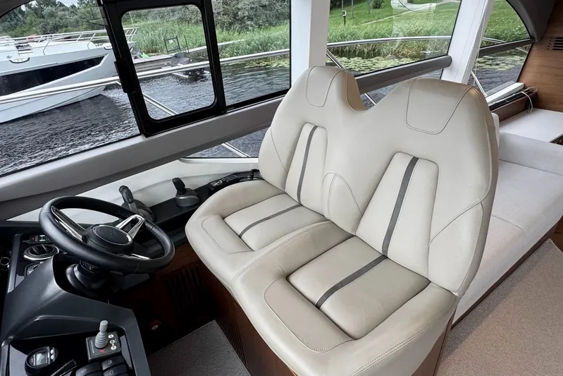  Yacht Photos Pics Interior of 2022 Princess F50 yacht with luxurious seating and steering wheel.