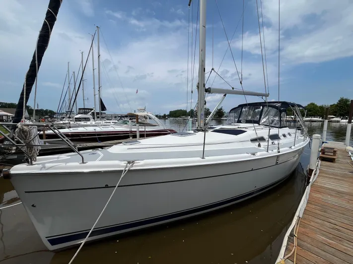  Yacht Photos Pics 2004 Hunter 41 sailboat docked at marina under blue sky.