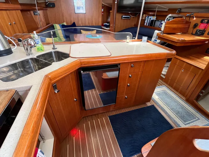  Yacht Photos Pics Interior of 2004 Hunter 41 sailboat kitchen with wood cabinetry and modern appliances.