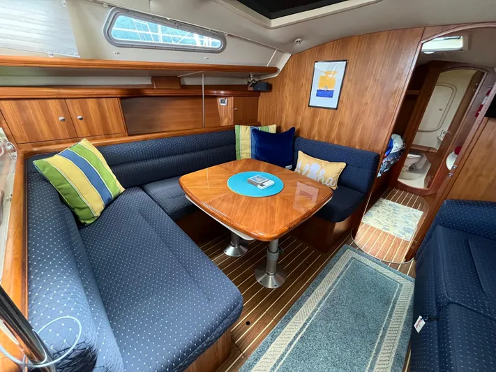  Yacht Photos Pics Interior of 2004 Hunter 41 sailboat with cozy seating and wooden table.
