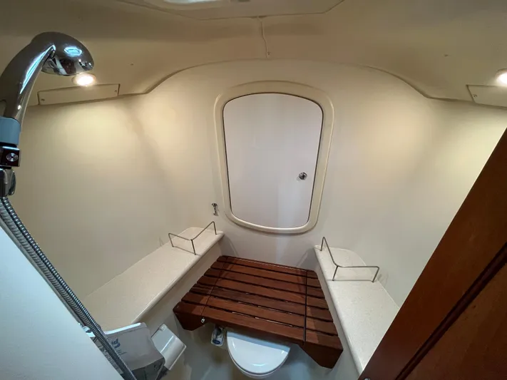  Yacht Photos Pics Bathroom interior of 2004 Hunter 41 yacht with shower and wooden seat.