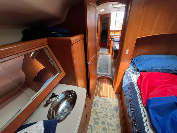  Yacht Photos Pics Interior of 2004 Hunter 41 sailboat with wood finish and cozy sleeping area.