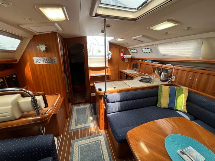  Yacht Photos Pics Interior of a 2004 Hunter 41 sailboat with wood finish and cozy seating area.