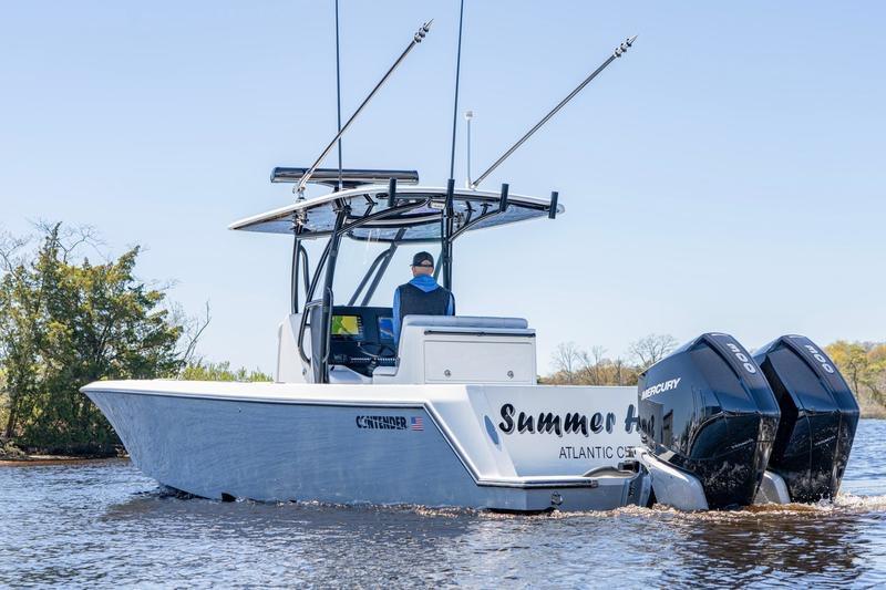 2022 Contender 32 ST boat with dual Mercury engines on a calm waterway.