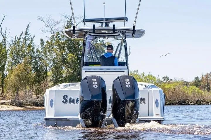  Yacht Photos Pics 2022 Contender 32 ST boat with dual 300 horsepower engines on a scenic waterway.