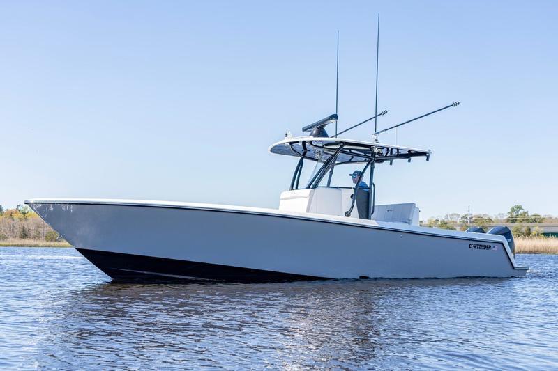 2022 Contender 32 ST boat on calm water, side view.