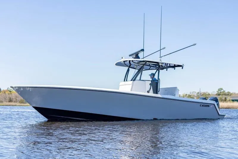  Yacht Photos Pics 2022 Contender 32 ST boat on calm water, side view.