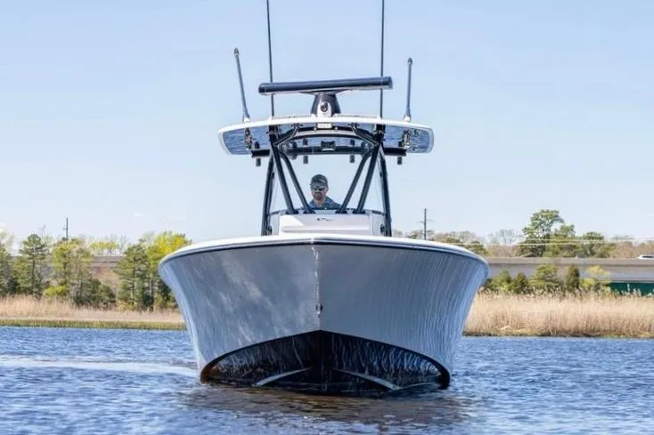  Yacht Photos Pics 2022 Contender 32 ST boat cruising on a calm waterway, front view.