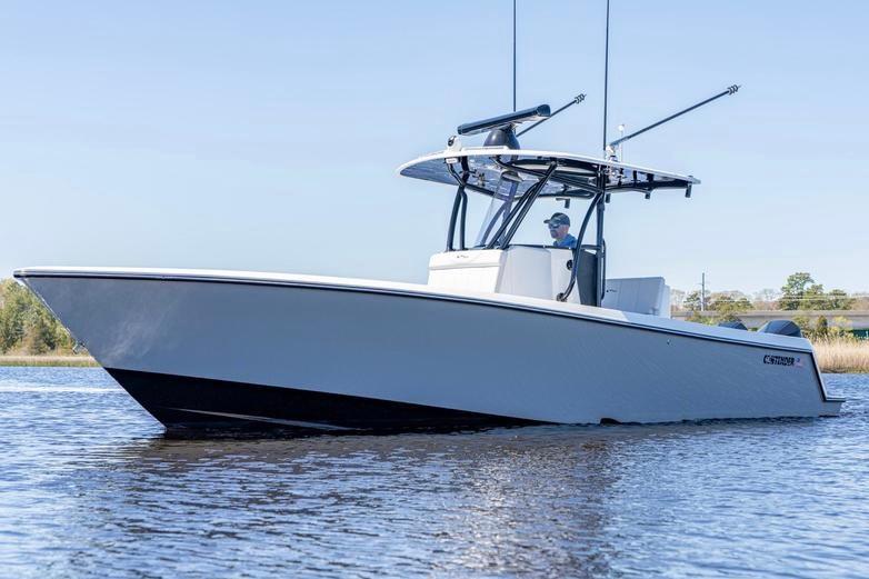 2022 Contender 32 ST boat on calm water, featuring sleek design and modern features.