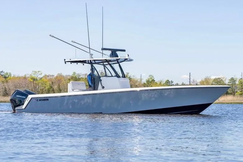  Yacht Photos Pics 2022 Contender 32 ST boat on calm water, featuring sleek design and powerful engines.