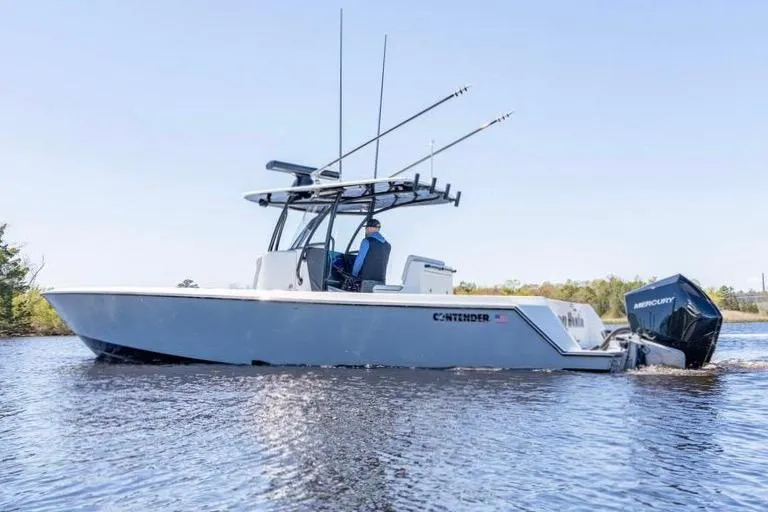  Yacht Photos Pics 2022 Contender 32 ST boat on water, featuring Mercury engines and fishing rod holders.