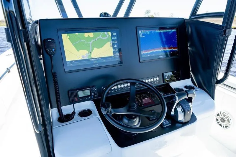  Yacht Photos Pics 2022 Contender 32 ST boat dashboard with navigation screens and controls.