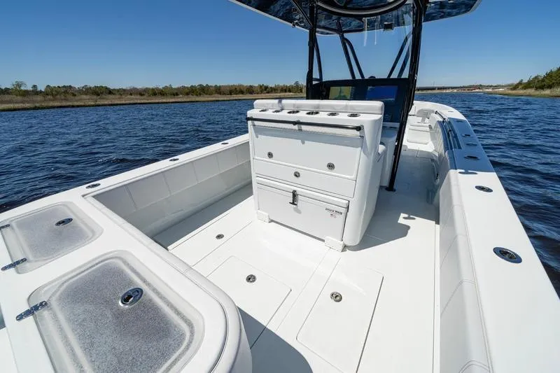  Yacht Photos Pics 2022 Contender 32 ST boat interior on water, featuring spacious deck and storage compartments.