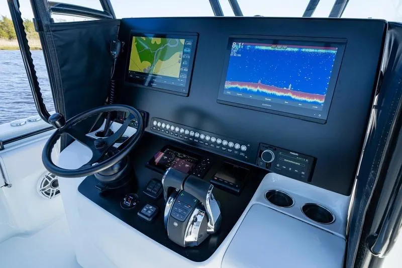  Yacht Photos Pics 2022 Contender 32 ST boat dashboard with navigation screens and controls.