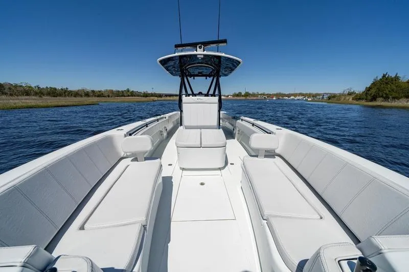  Yacht Photos Pics 2022 Contender 32 ST boat with spacious seating on calm water.