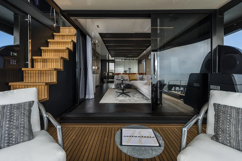 Yacht Photos Pics Luxurious interior of 2026 Cranchi Settantotto 78 yacht with modern seating and wooden staircase.