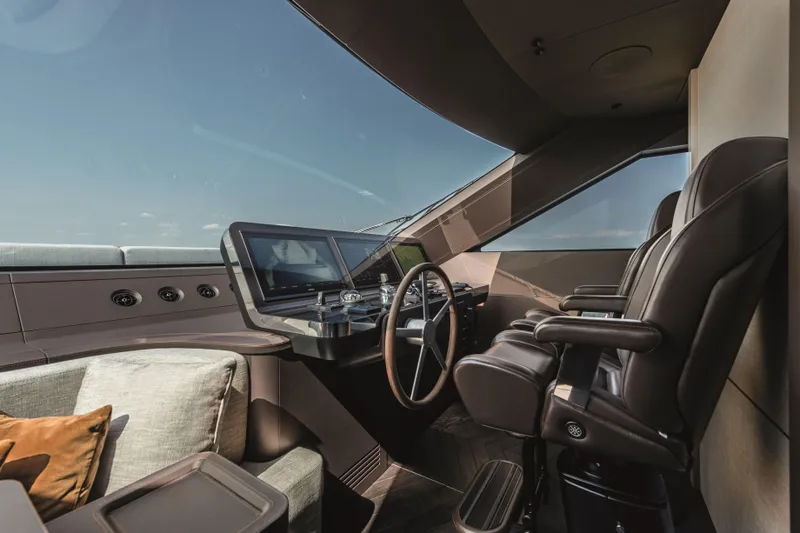  Yacht Photos Pics Luxurious helm of 2026 Cranchi Settantotto 78 yacht with modern controls and leather seating.