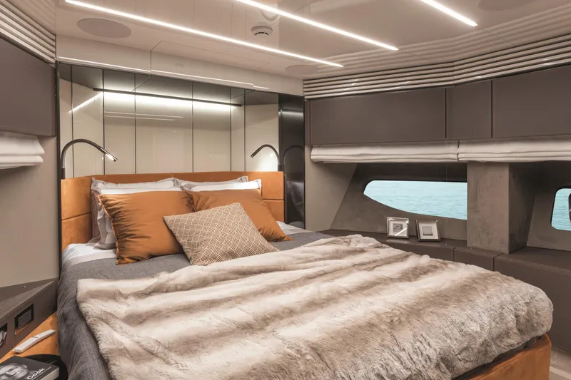  Yacht Photos Pics Luxurious bedroom interior of 2026 Cranchi Settantotto 78 yacht with modern design and cozy bedding.